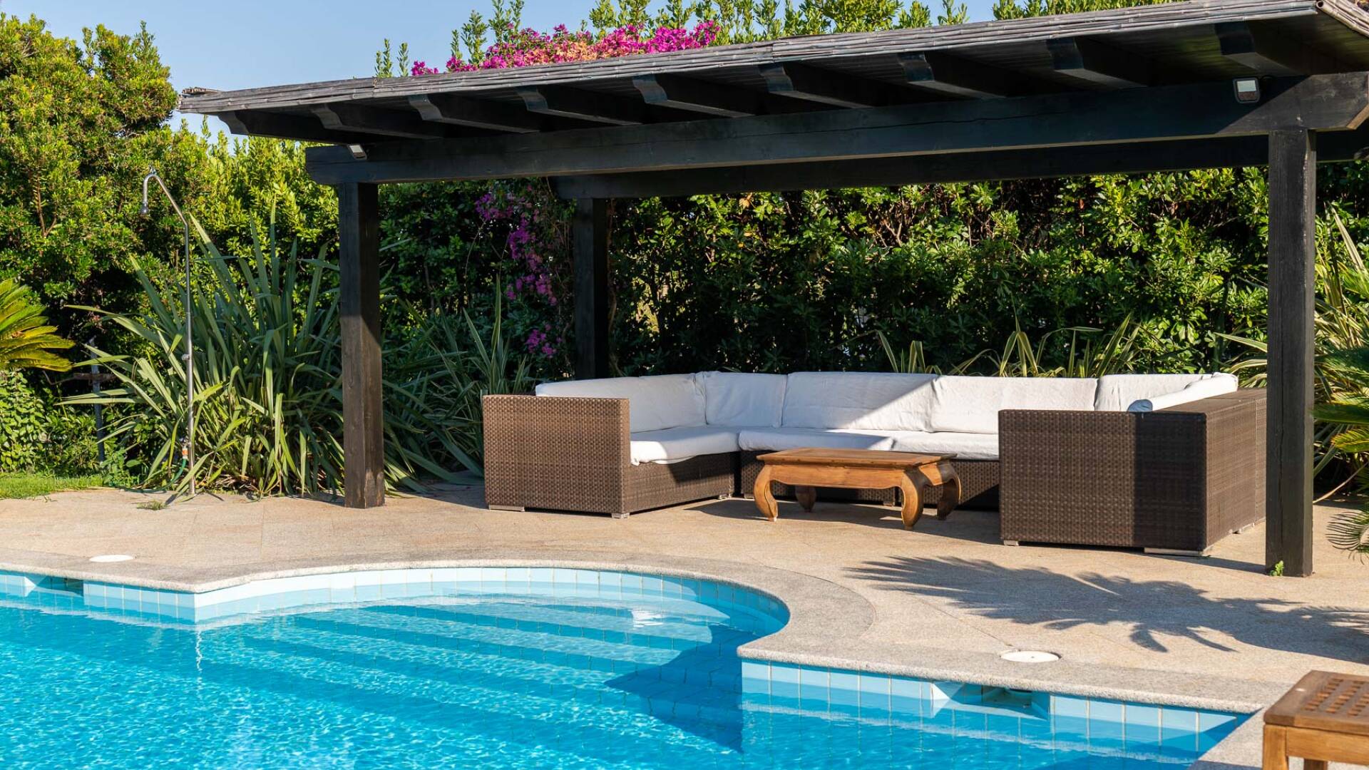 covered sitting area by the pool
