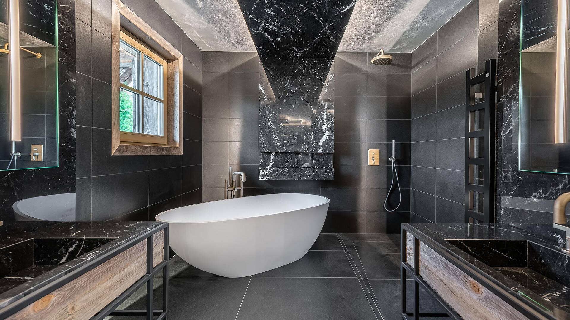 en suite bathroom with bath tub and double lavabo