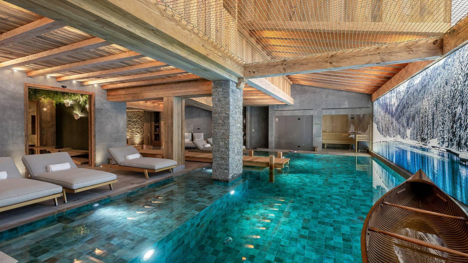 majestic indoor pool with sunbeds and canoe
