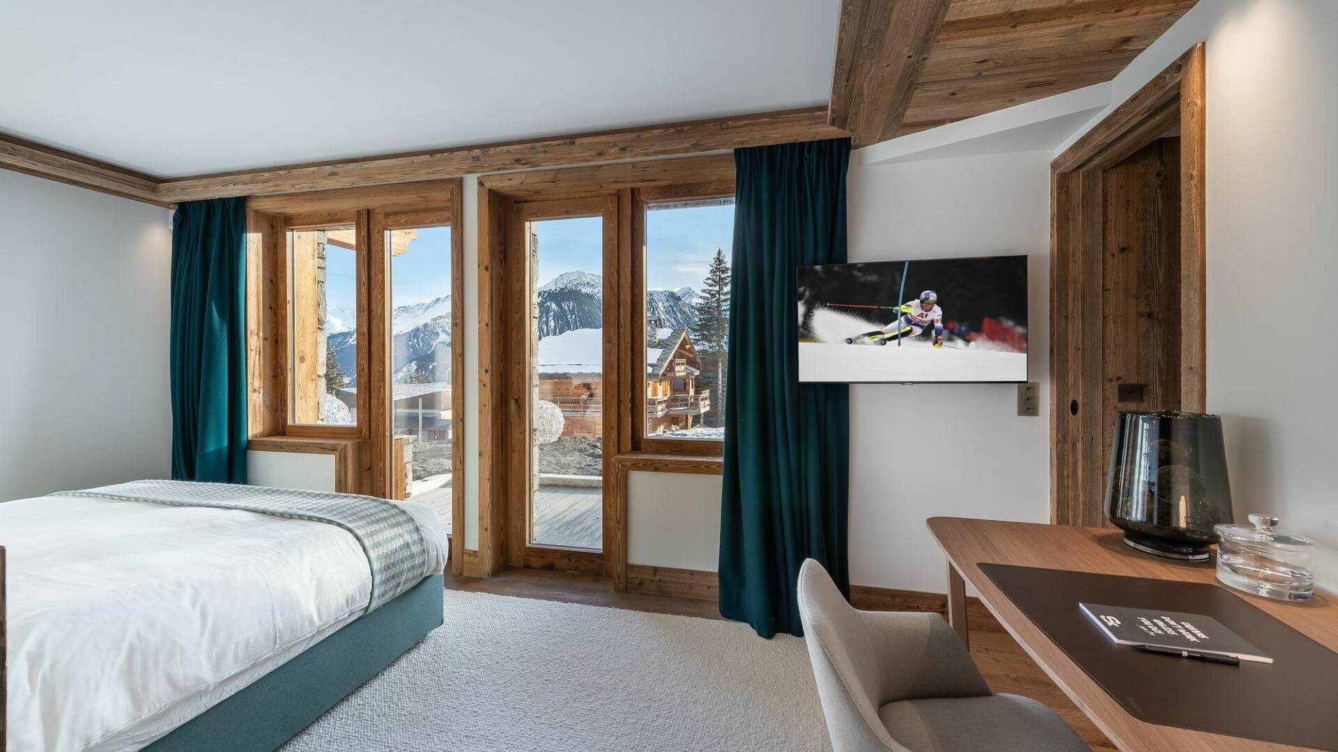 double bedroom with TV and access to outdoor