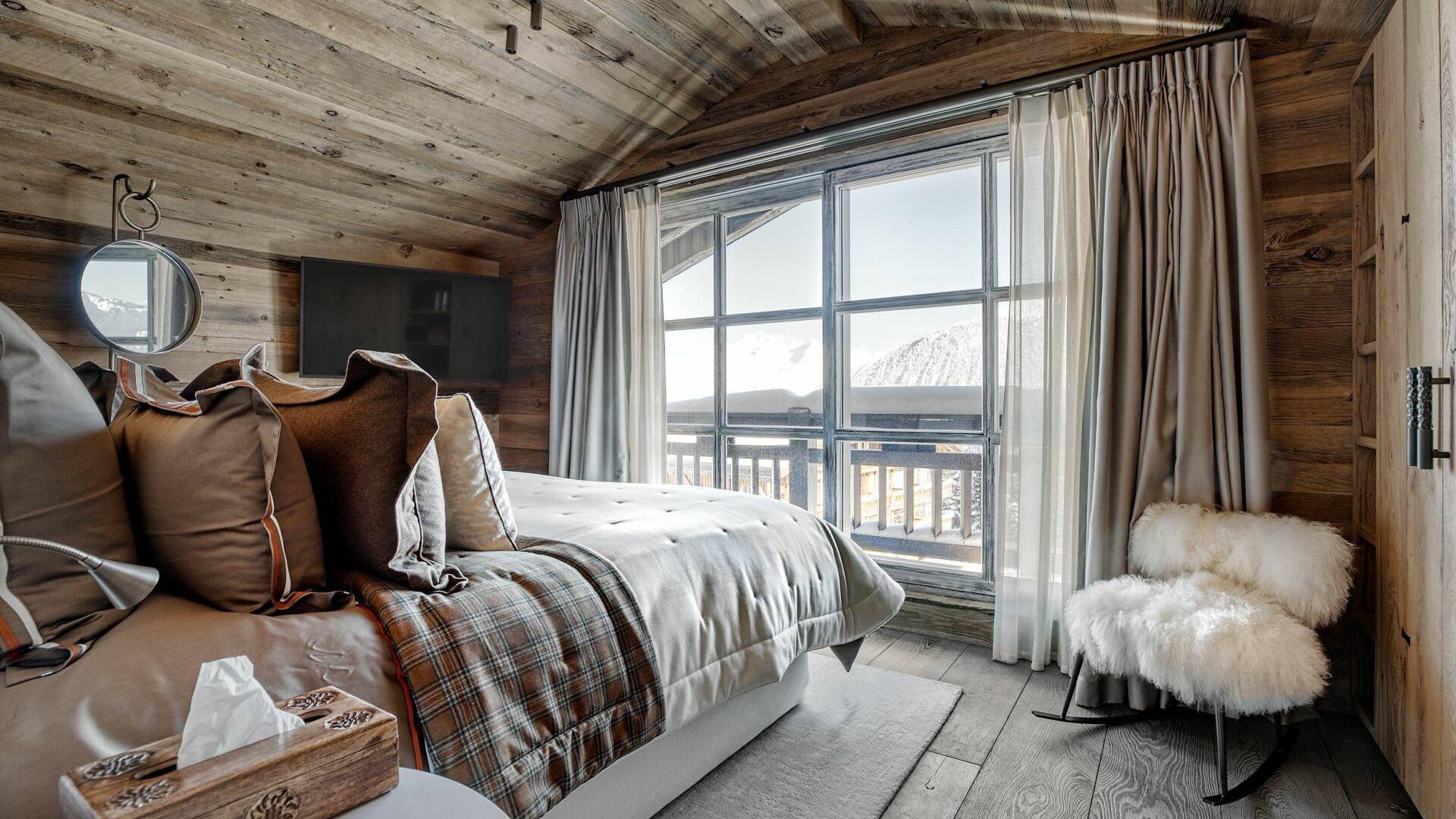 spacious double bedroom with French windows and view over Courchevel