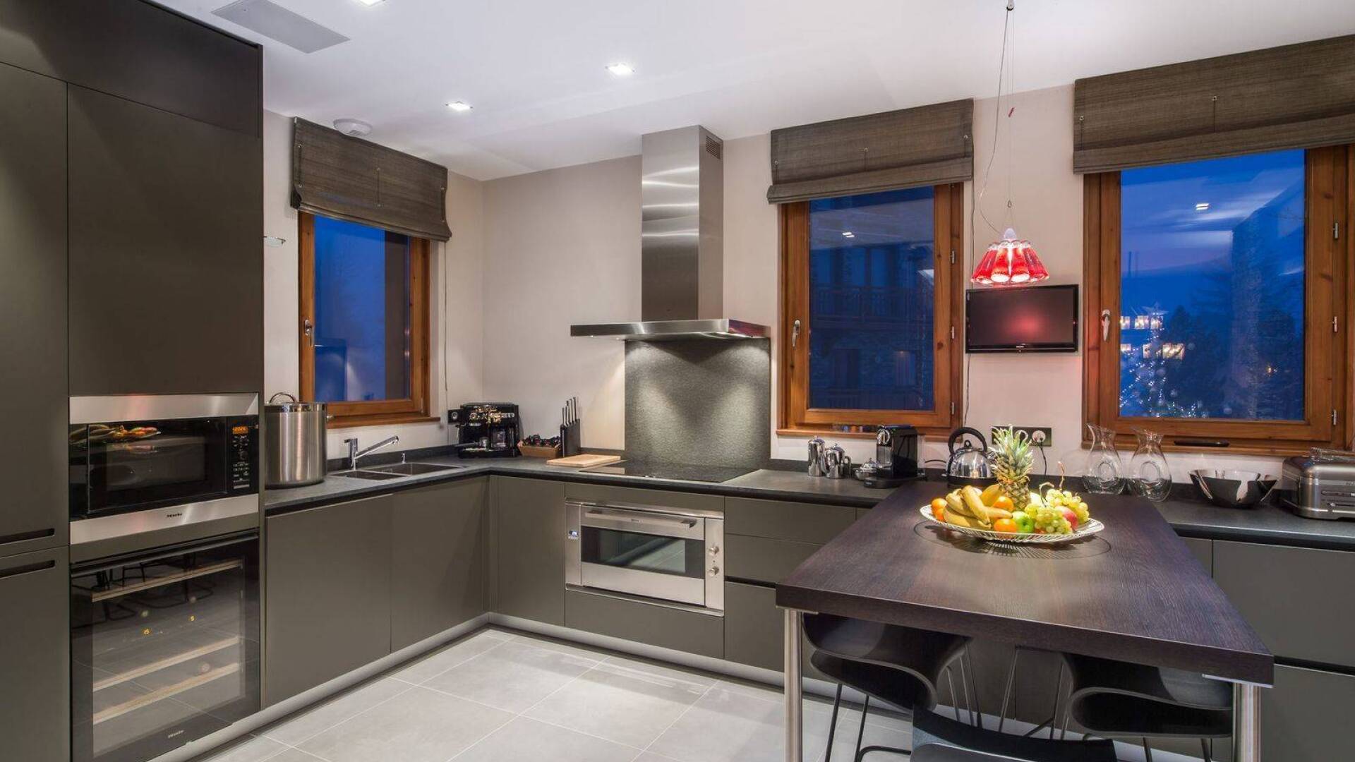 modern kitchen with cooking island and stools