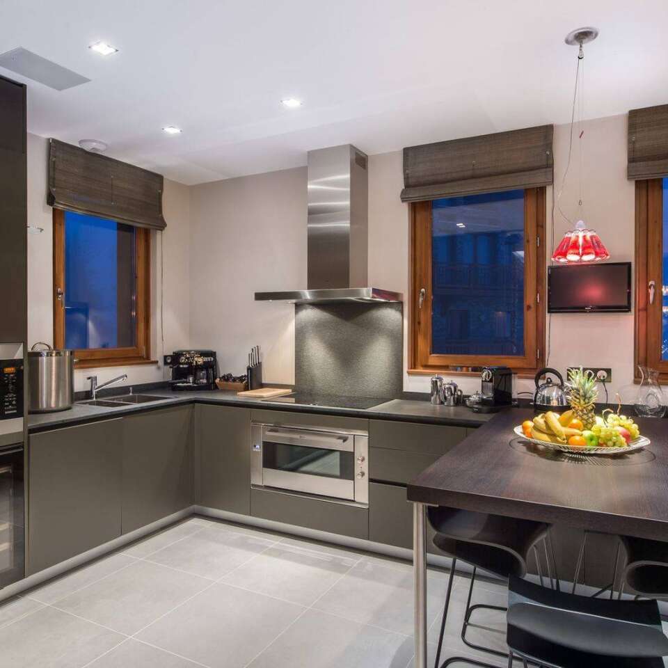 modern kitchen with cooking island and stools