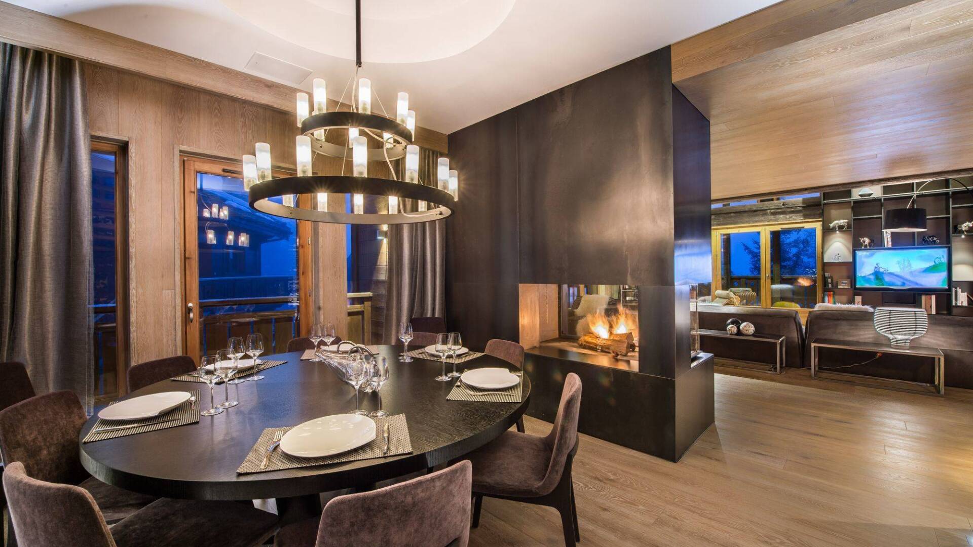 modern dining area with fireplace and TV