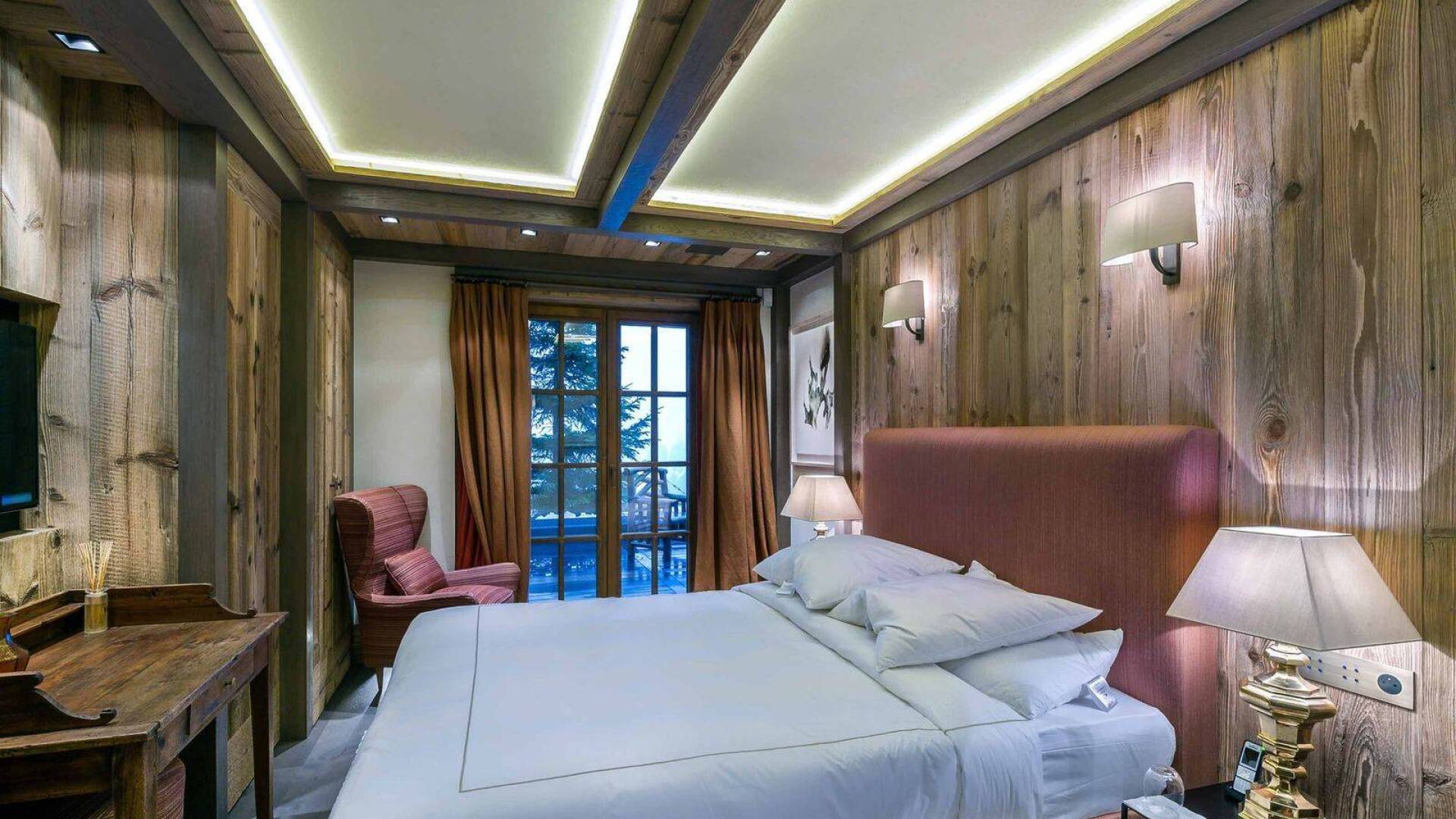 double bedroom with TV and access to balcony