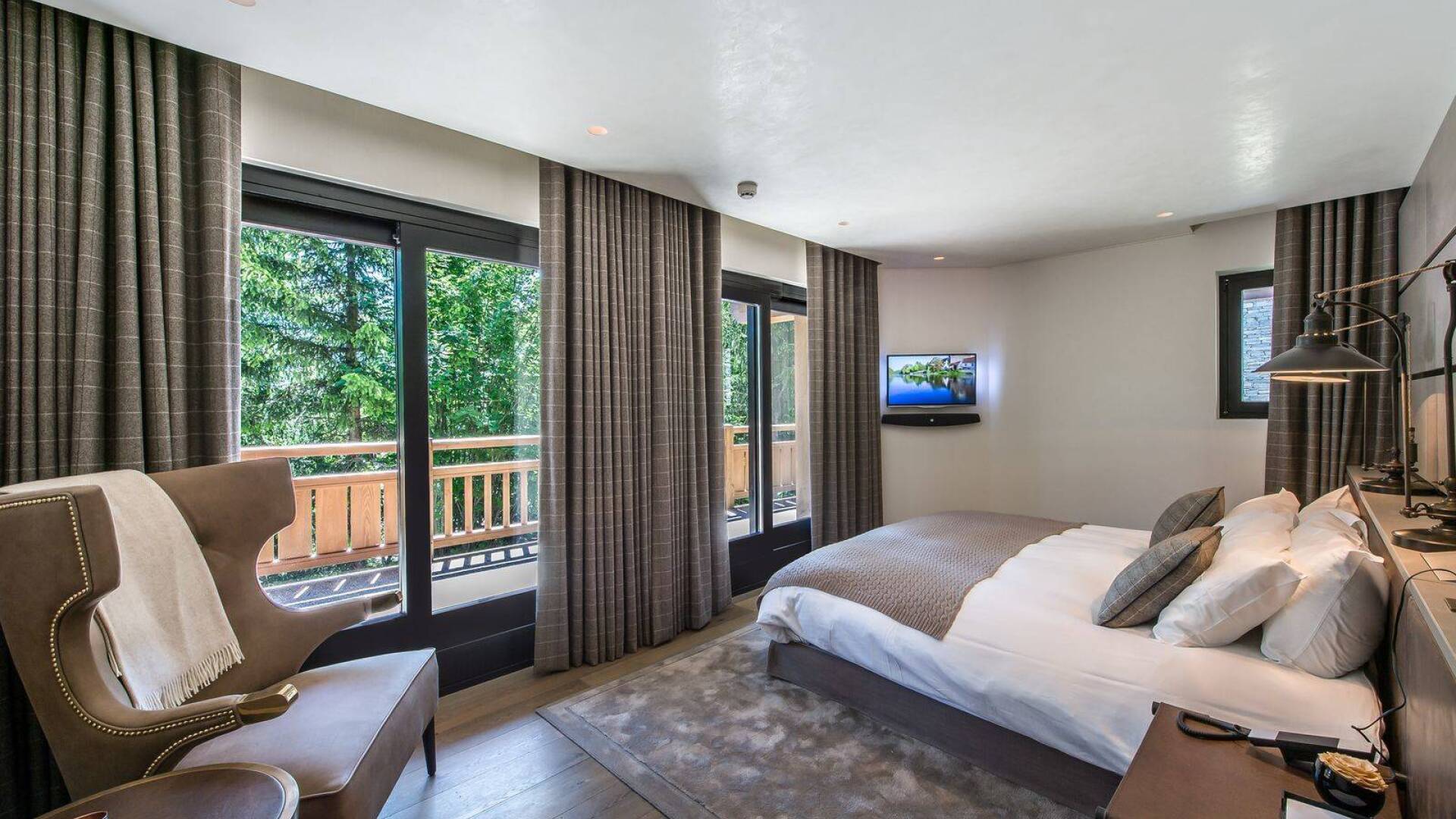double bedroom with TV and access to balcony