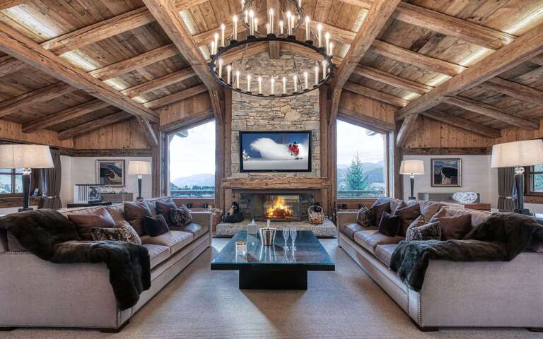 opulent living room with majestic French windows, fireplace and TV