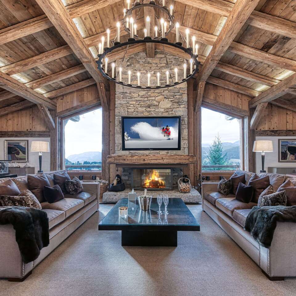 opulent living room with majestic French windows, fireplace and TV