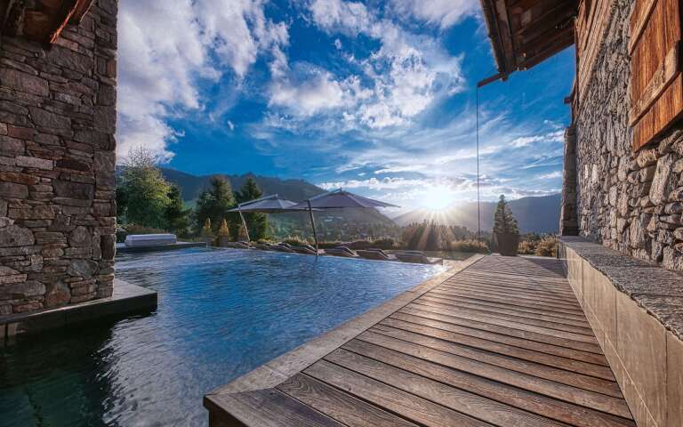 luxury indoor/outdoor swimming pool with sunbeds