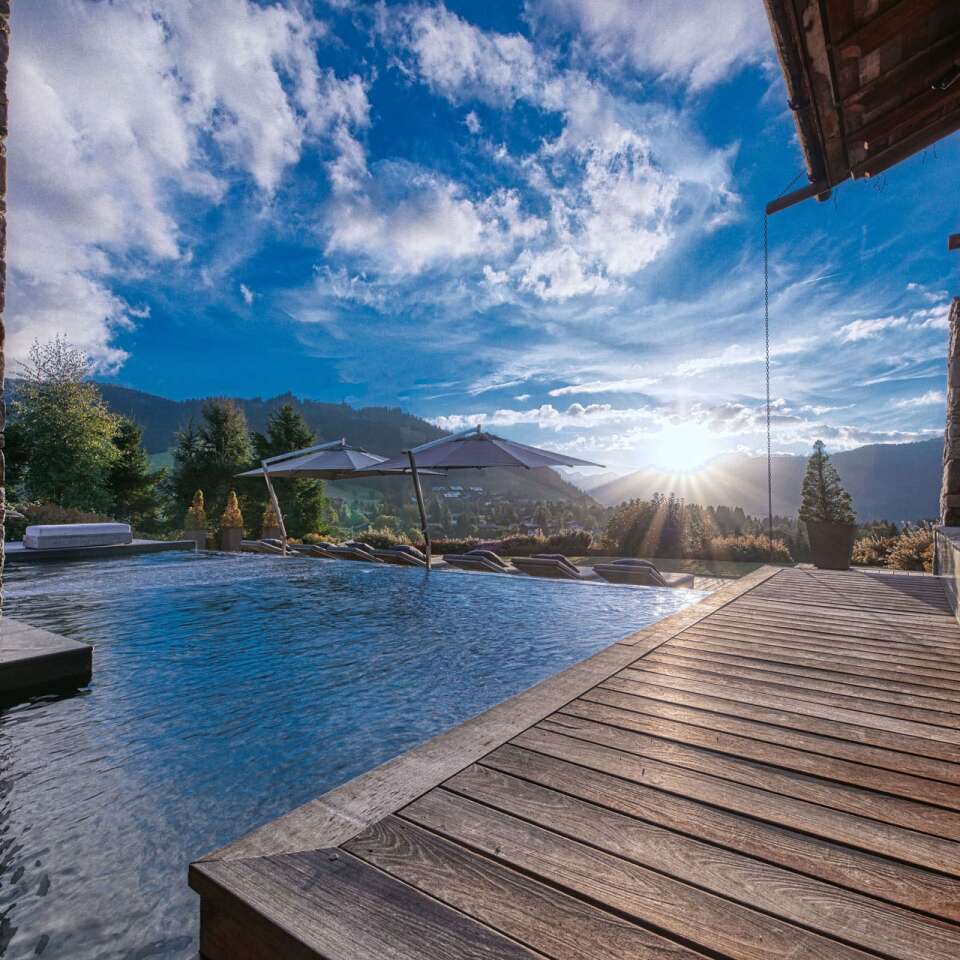 luxury indoor/outdoor swimming pool with sunbeds