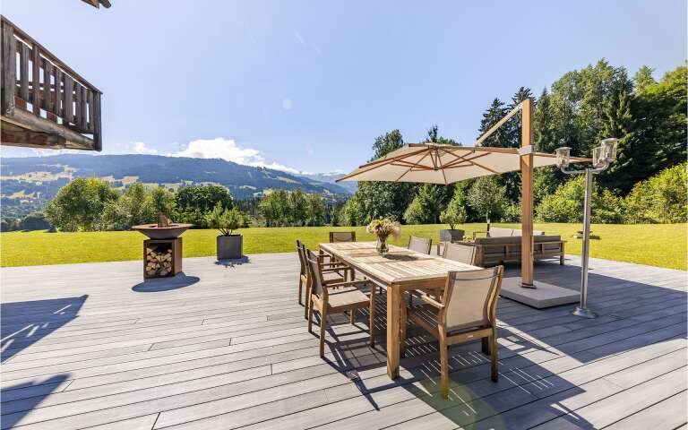 spacious private garden with sitting area and dining table
