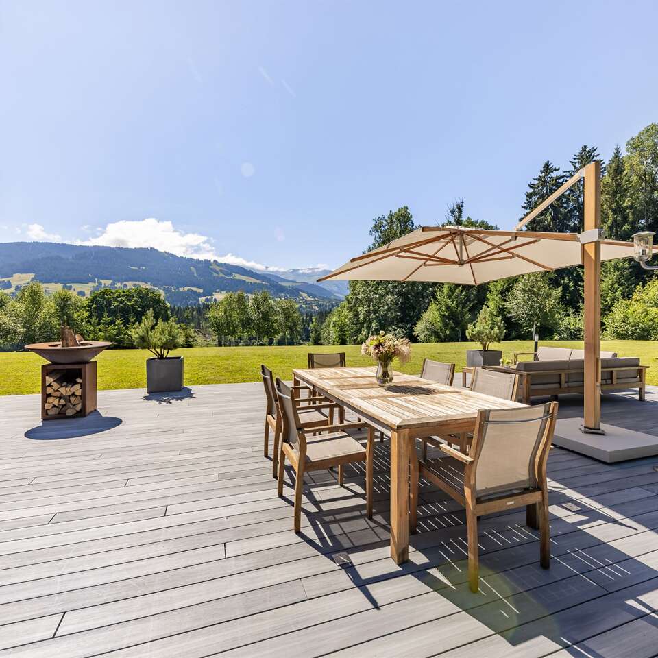 spacious private garden with sitting area and dining table