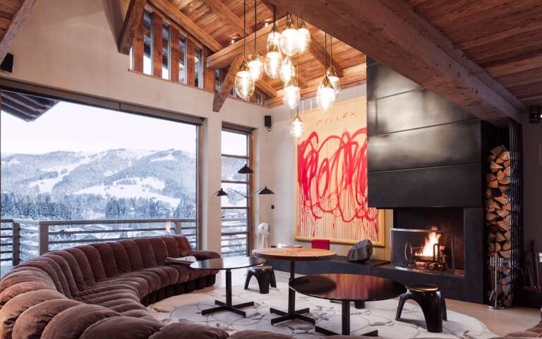 living room with large sofa, fireplace and French windows