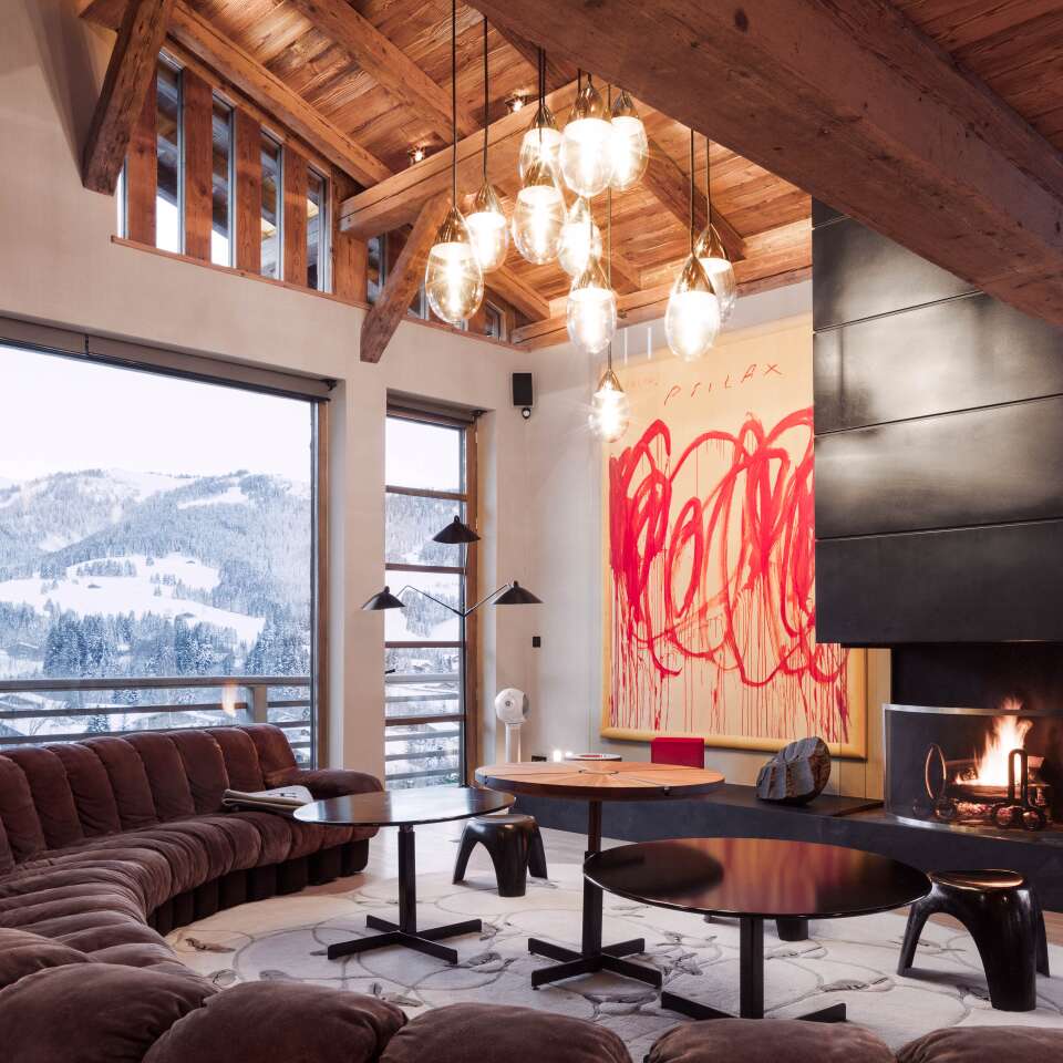 living room with large sofa, fireplace and French windows