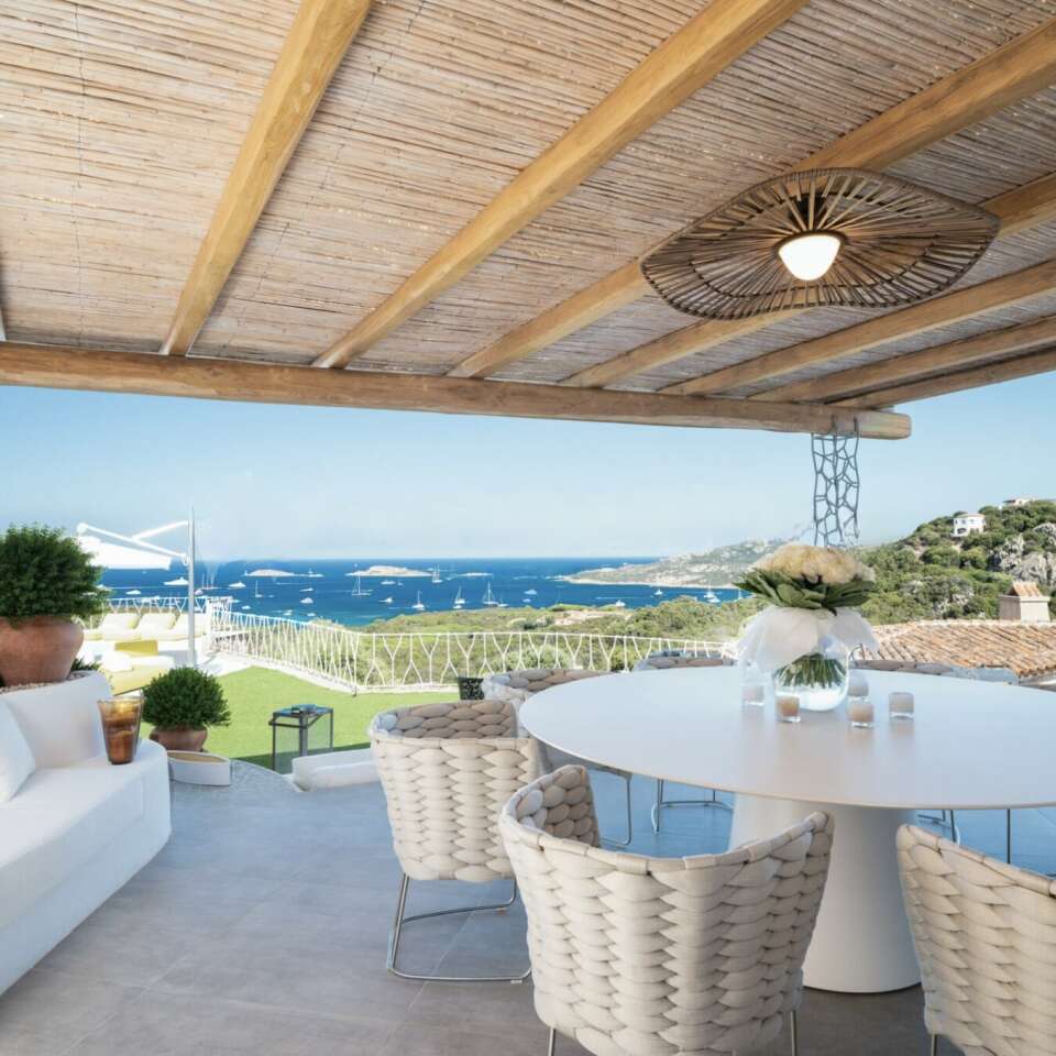 alfresco dining area with pool and sea view