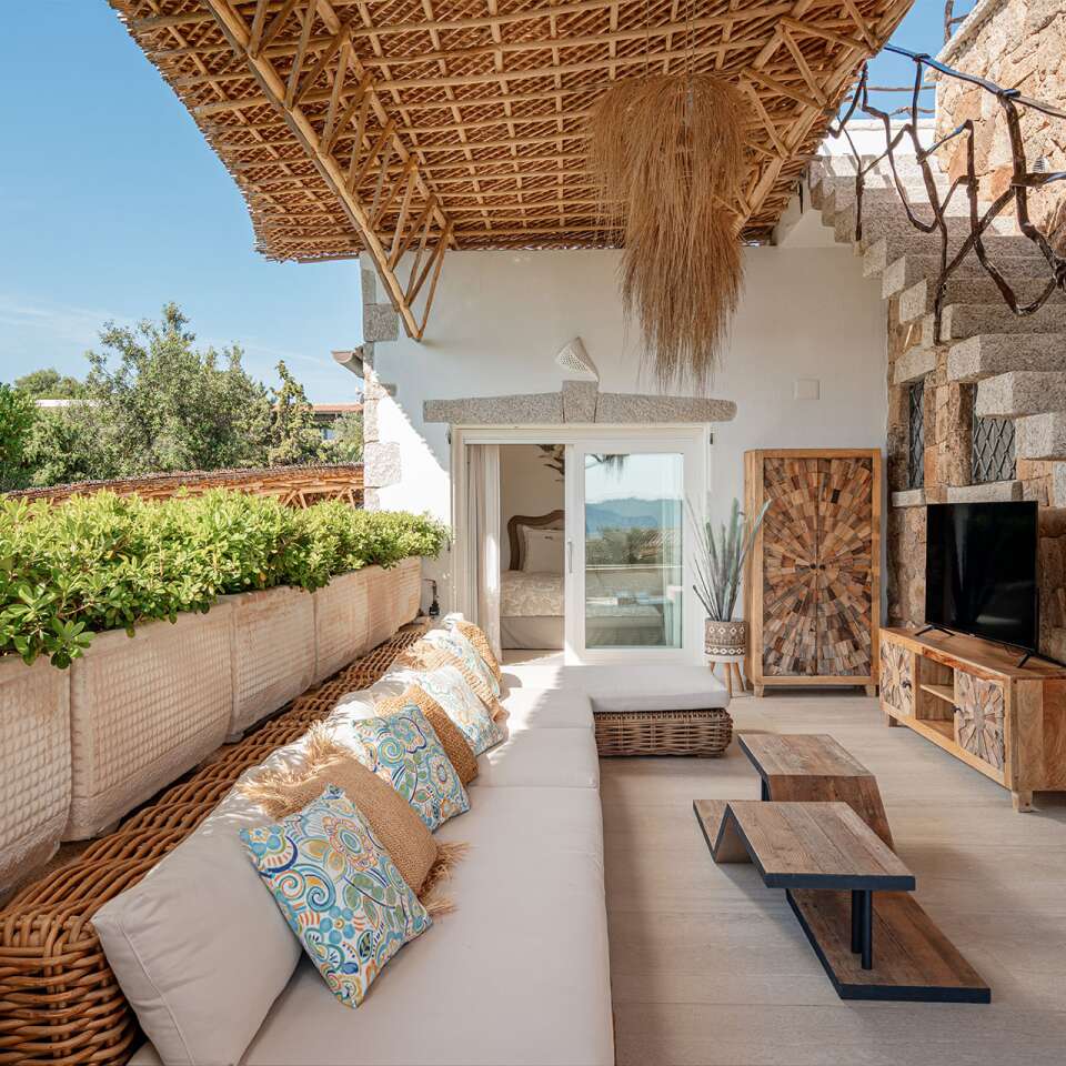 covered outdoor sitting area with TV