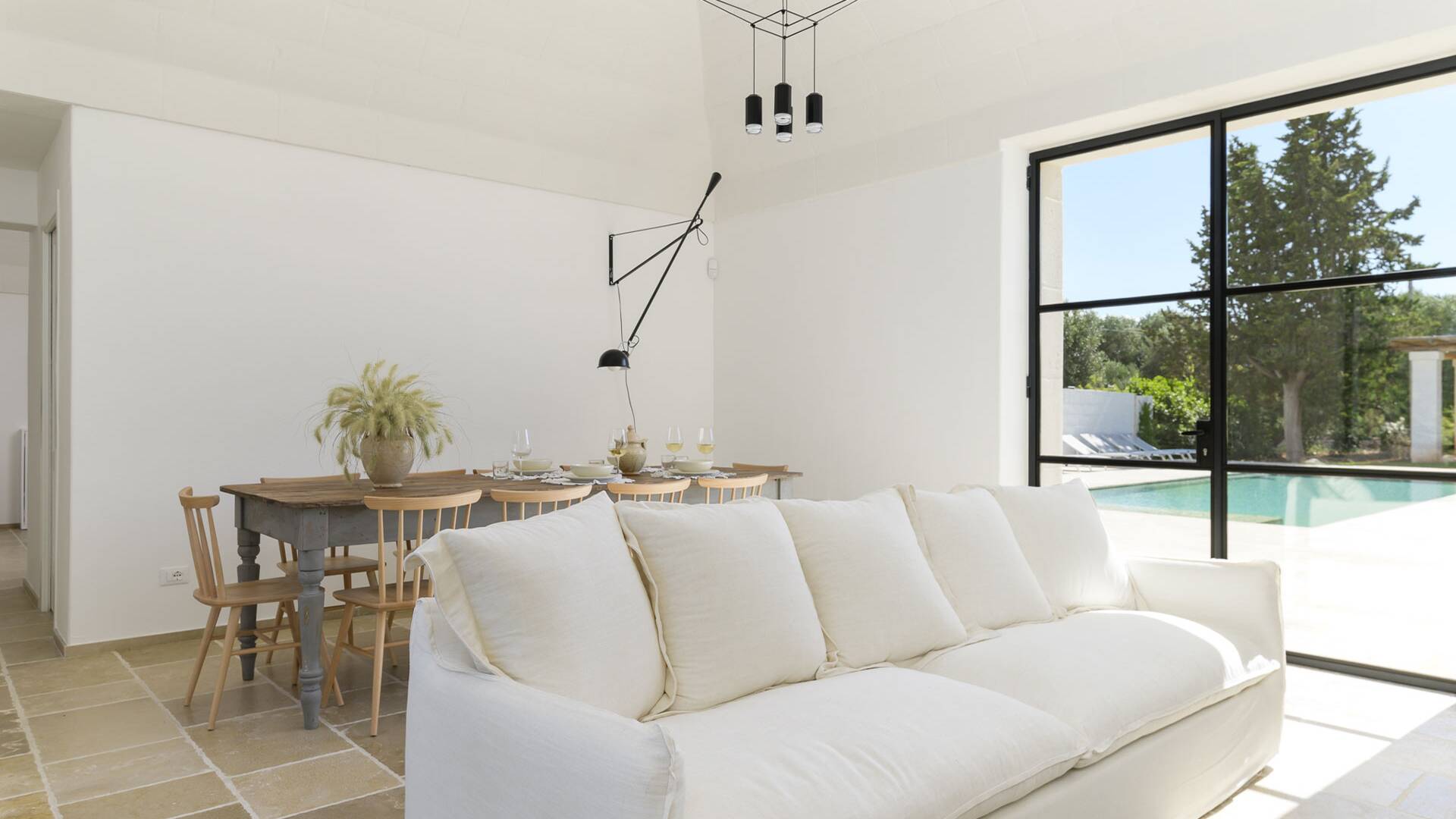 main villa, living and dining room with pool view