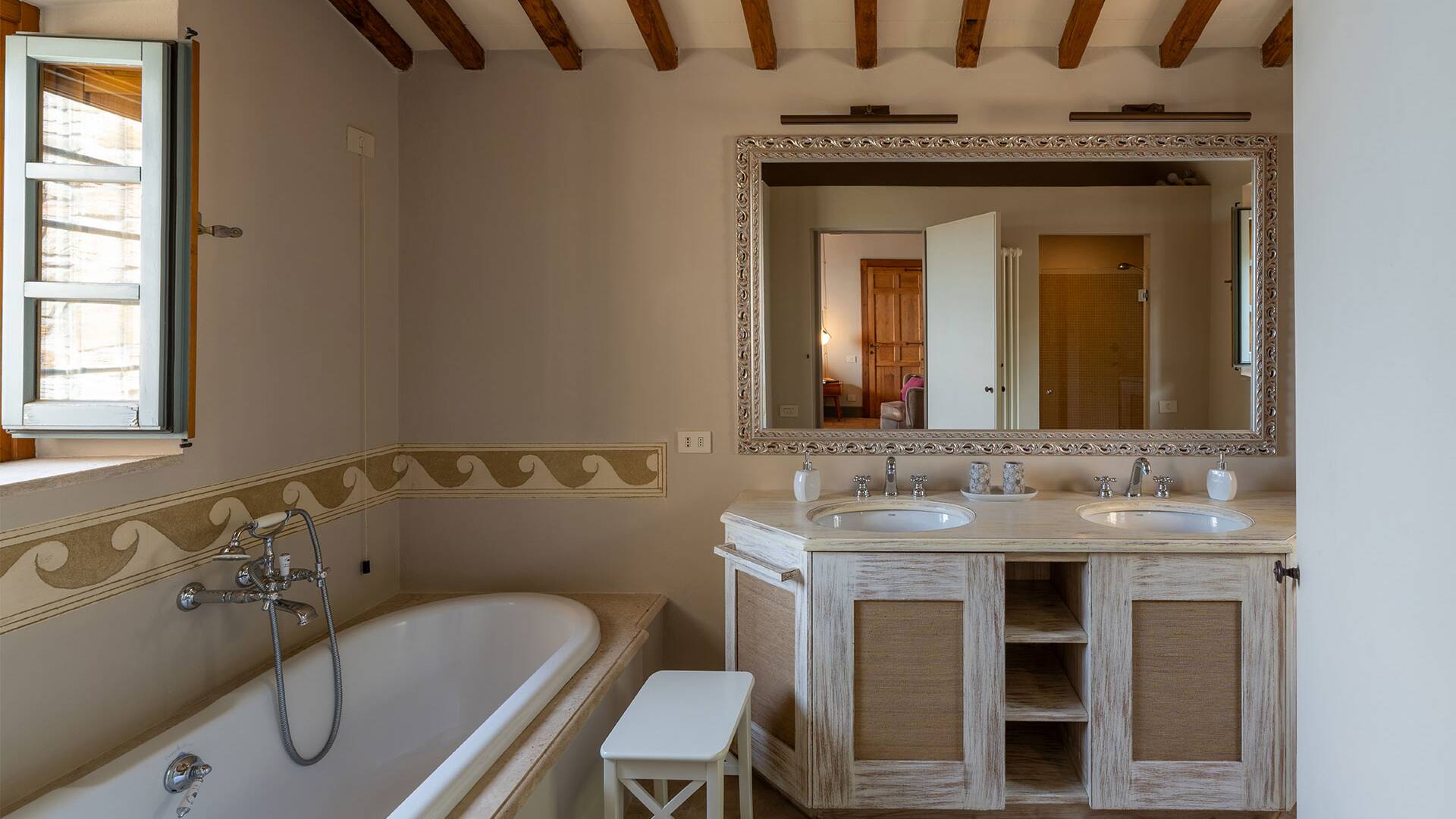en suite bathroom with double basin and bath tub