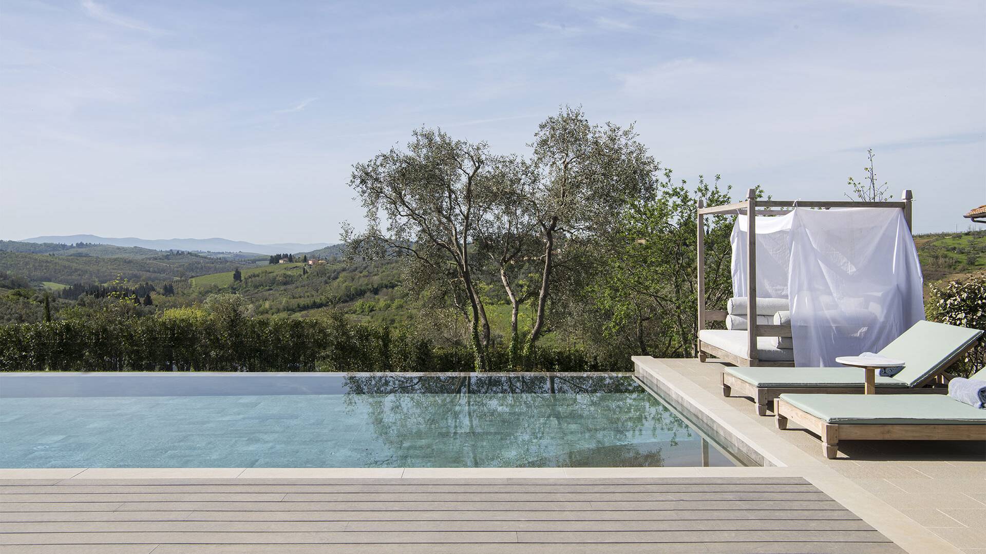 infinity pool with sunbeds
