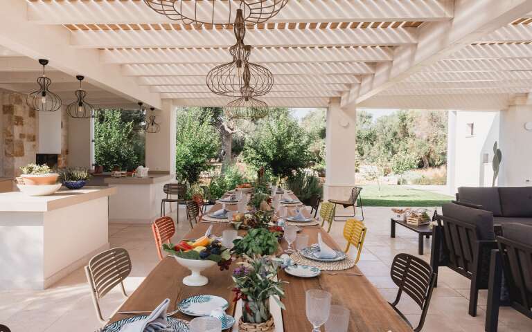pergola with dining table and open air living space