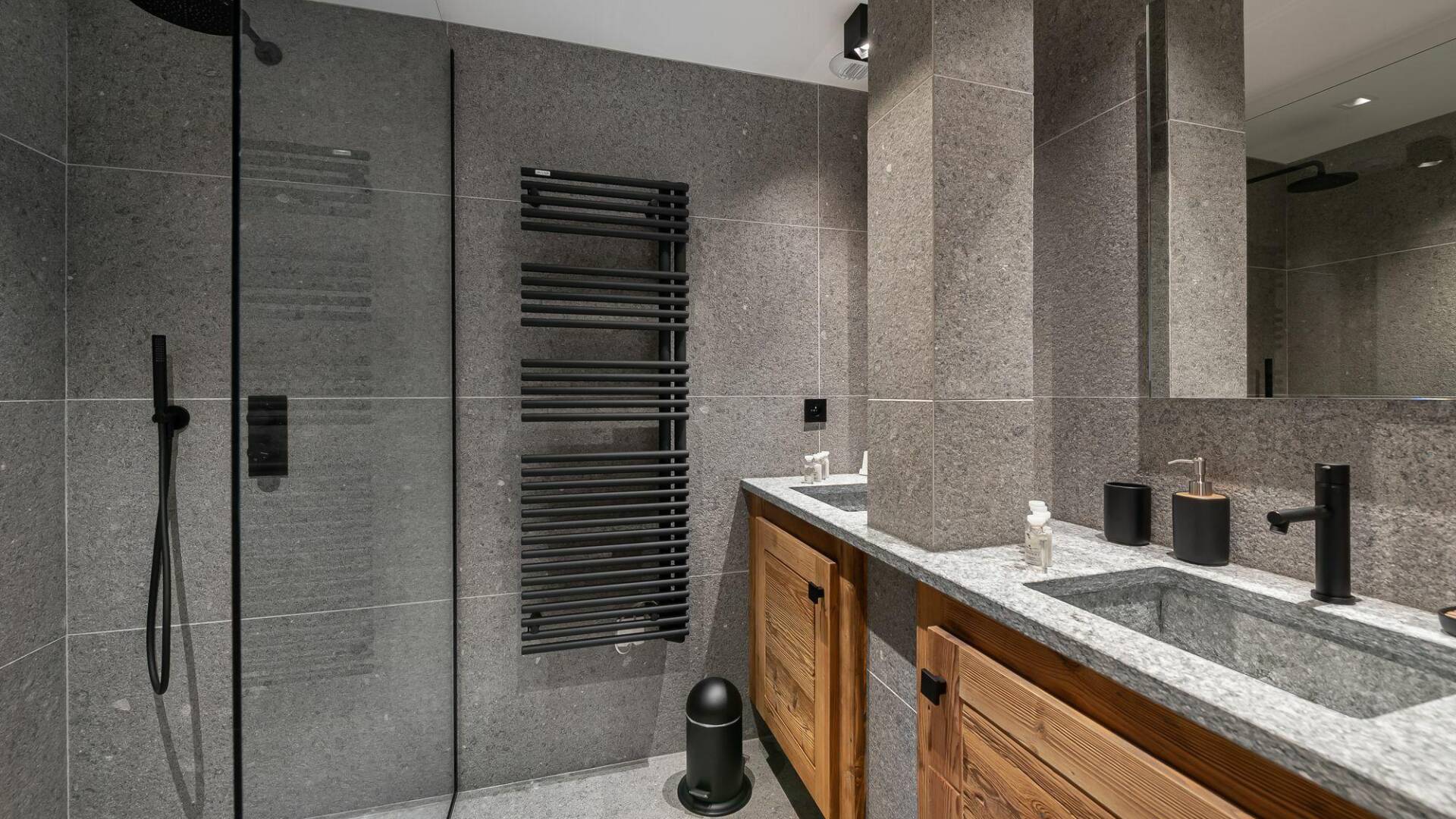 en suite bathroom with walk-in shower and towel dryer
