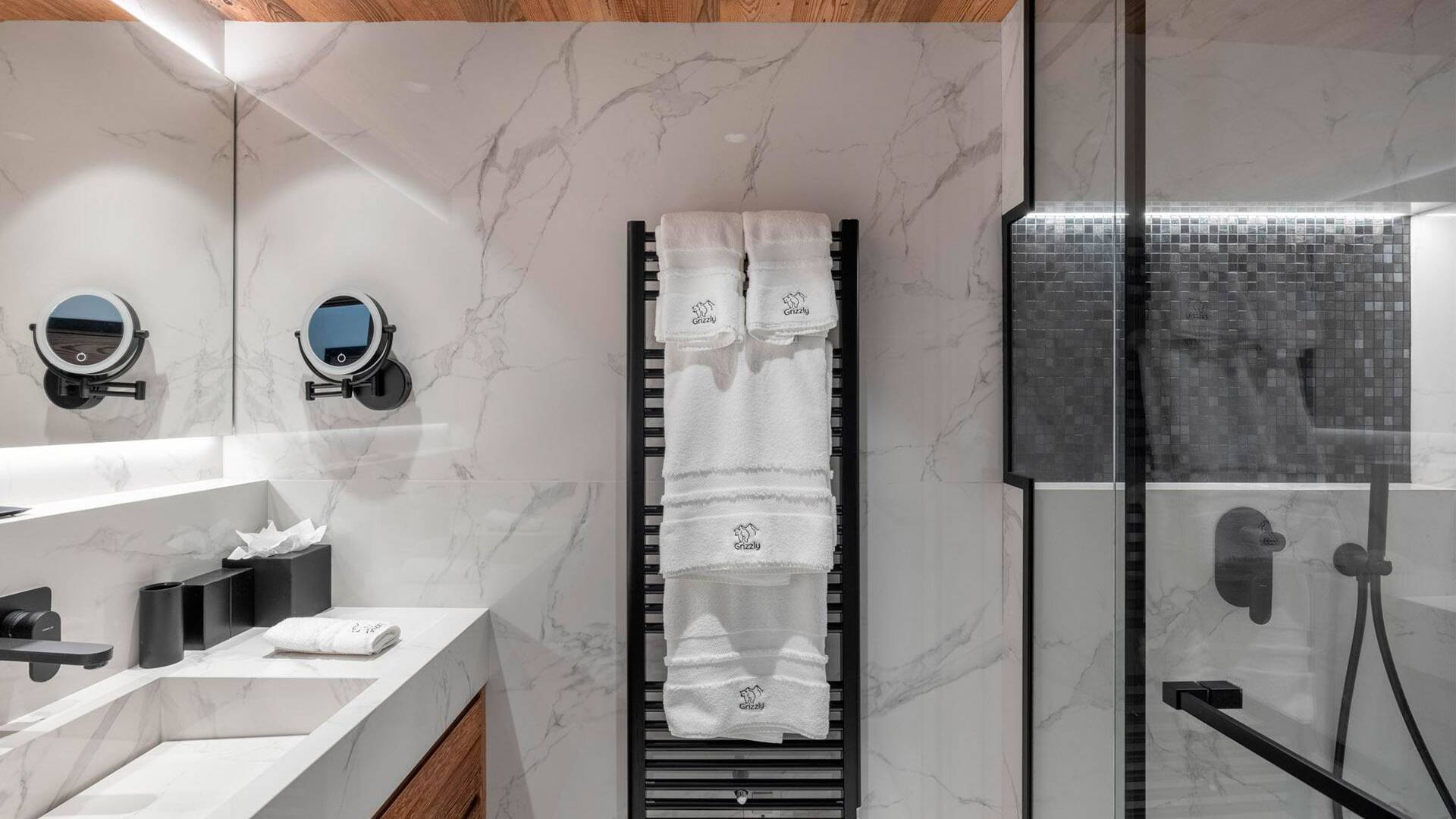 en suite bathroom with walk-in shower and towel dryer
