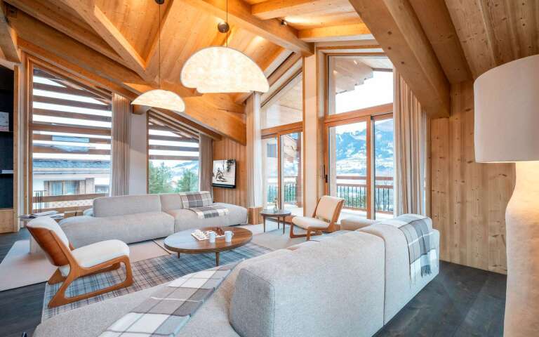 spacious living room with comfortable sofa and armchairs