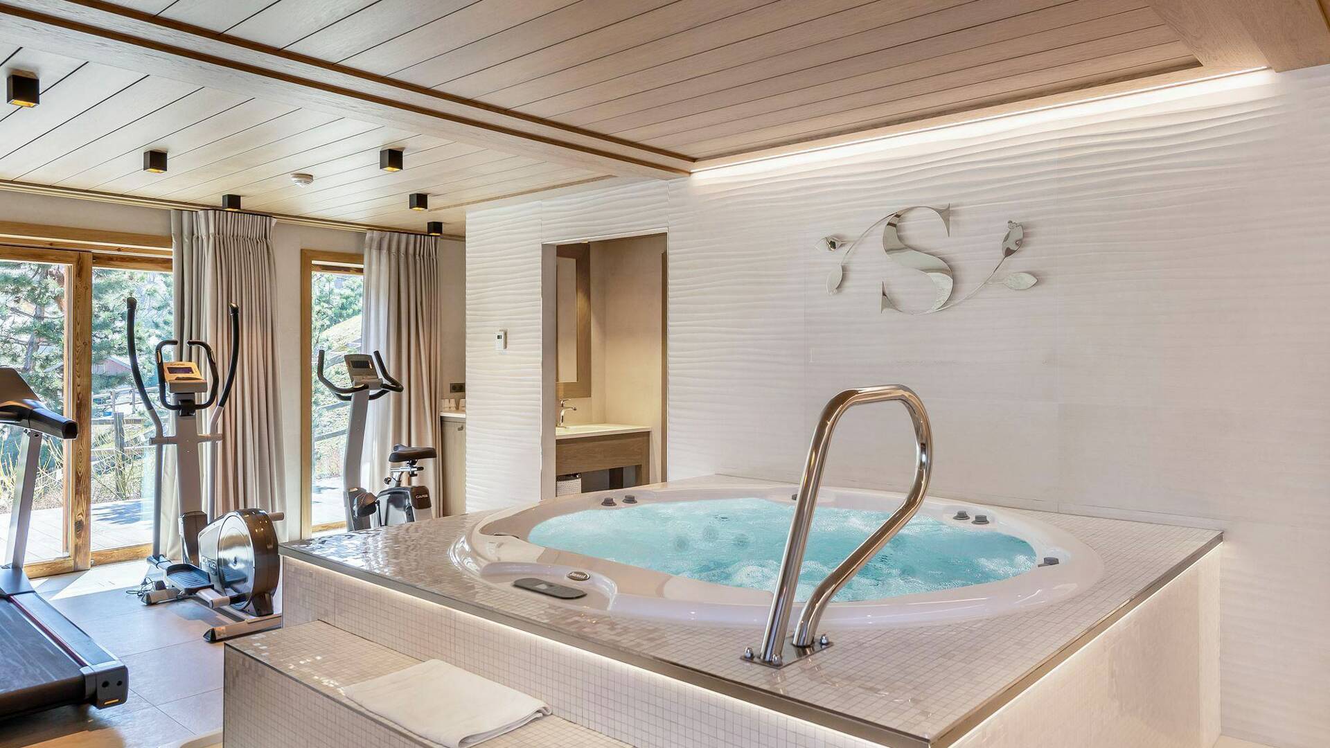wellness area featuring gym and hot tub