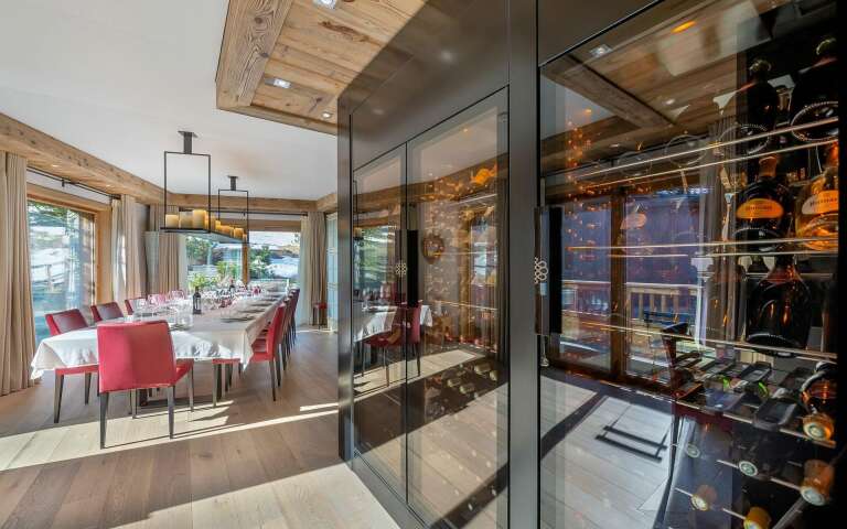 beautiful dining table featuring wine cellar