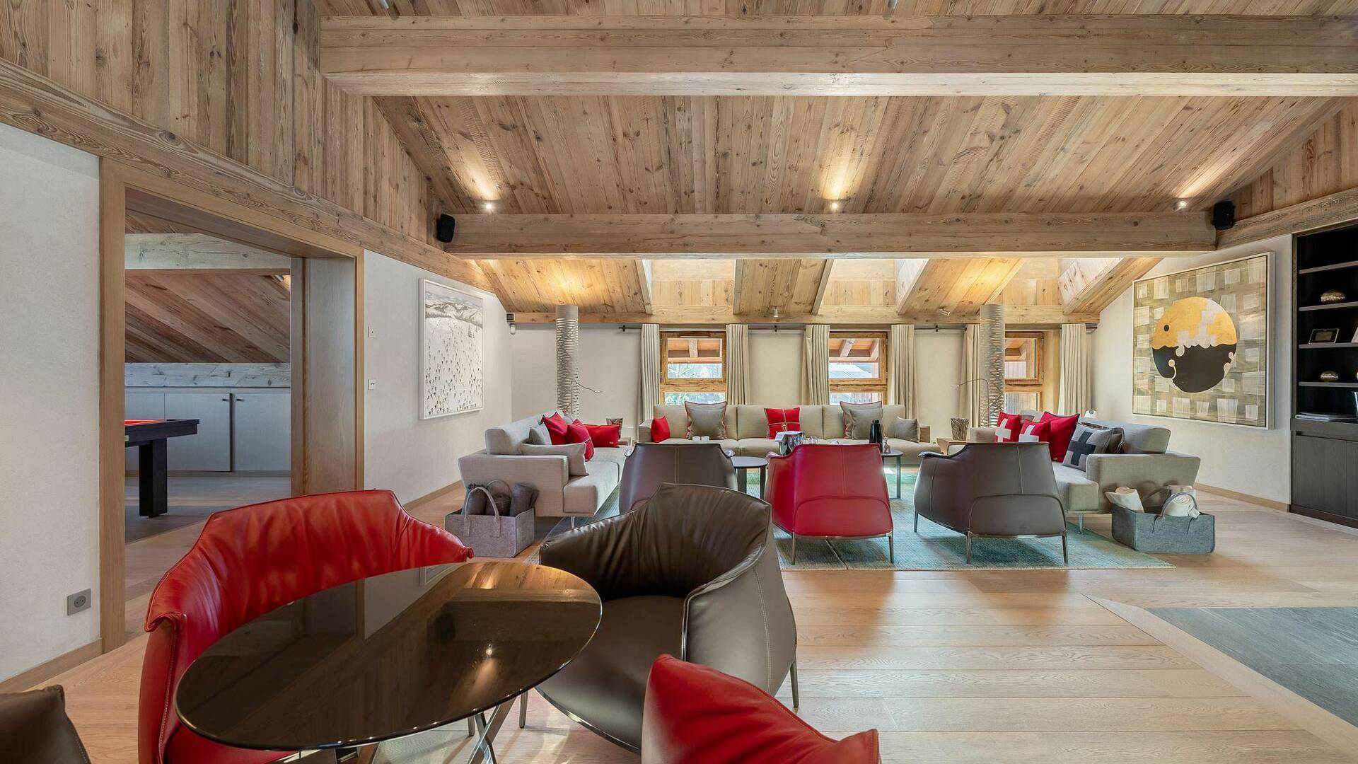 spacious elegant lounge featuring tables and armchairs