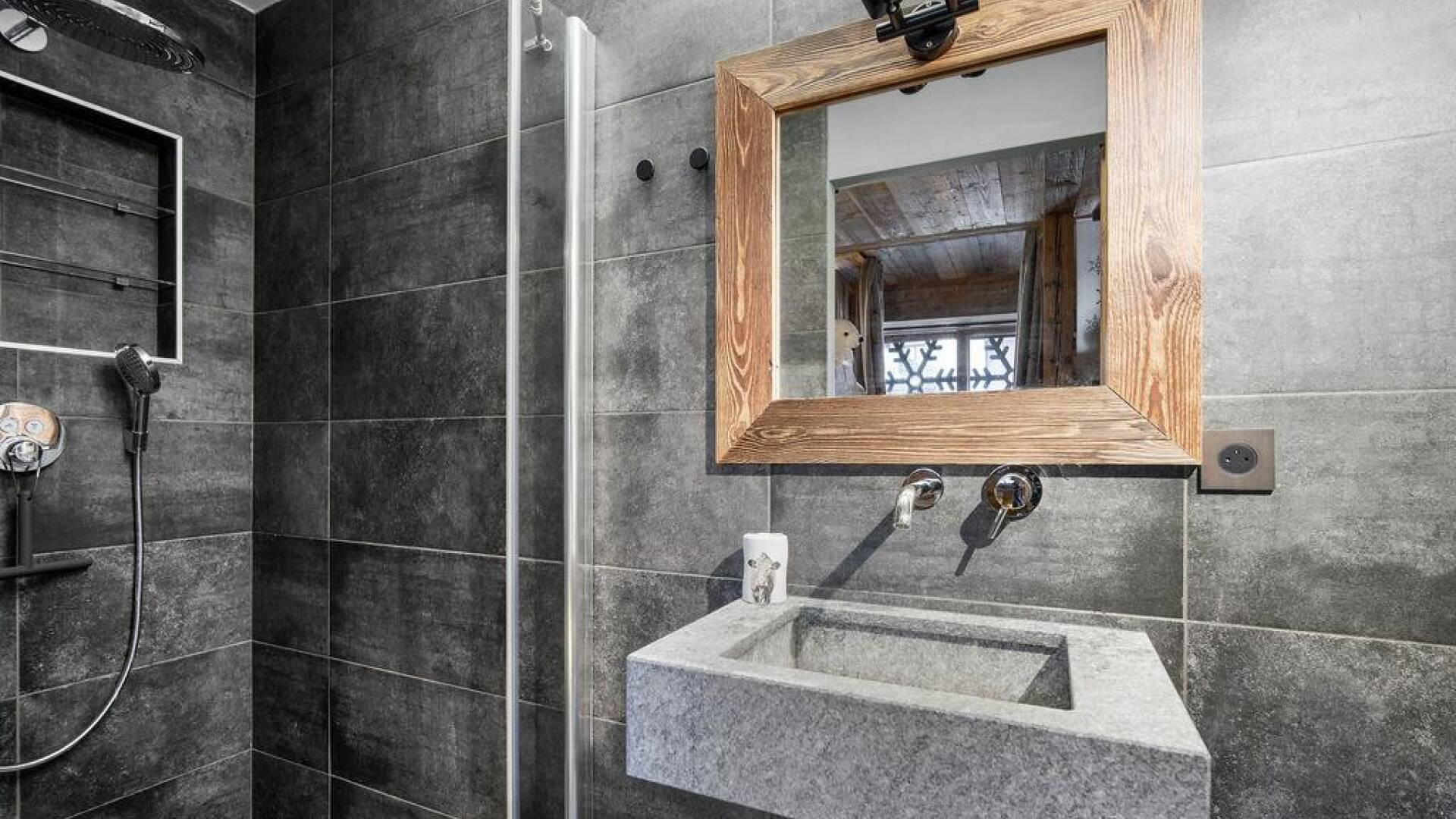 en suite bathroom with walk in shower and single hand basin 