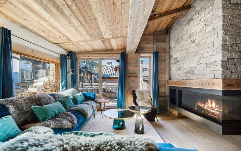 comfortable living room with large sofa and fireplace and access to the balcony 