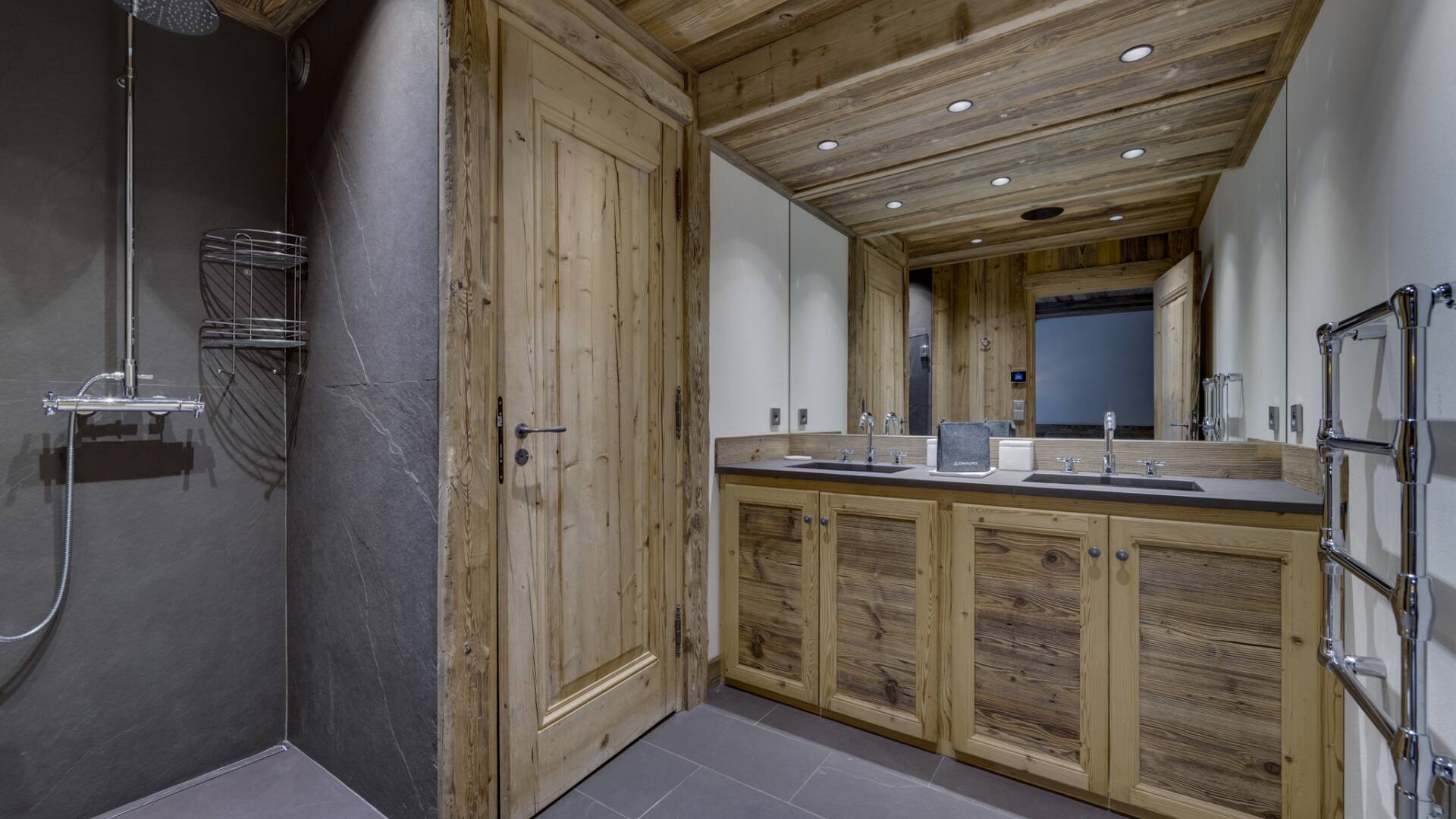 en suite bathroom with double sink and walk in shower
