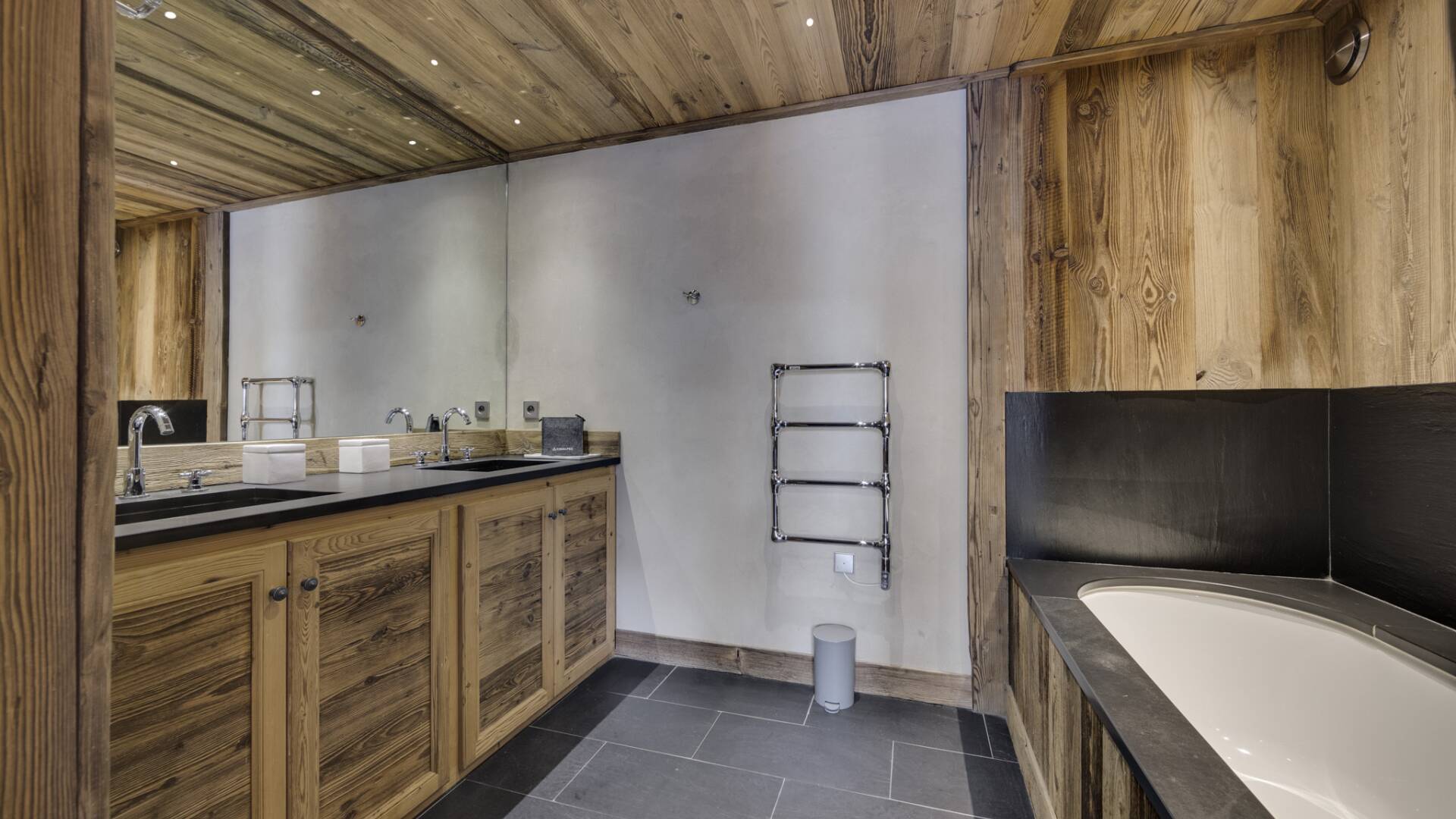 en suite double bedroom with bath tub and double sink