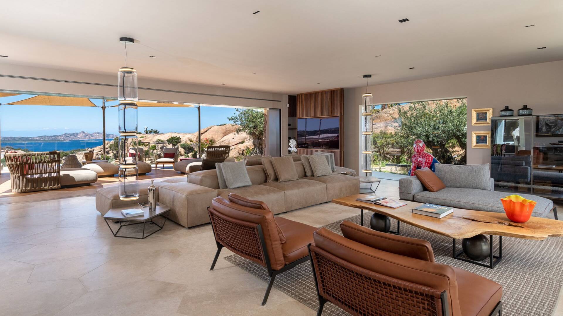 spacious open space living room with comfortable sofas and armchairs