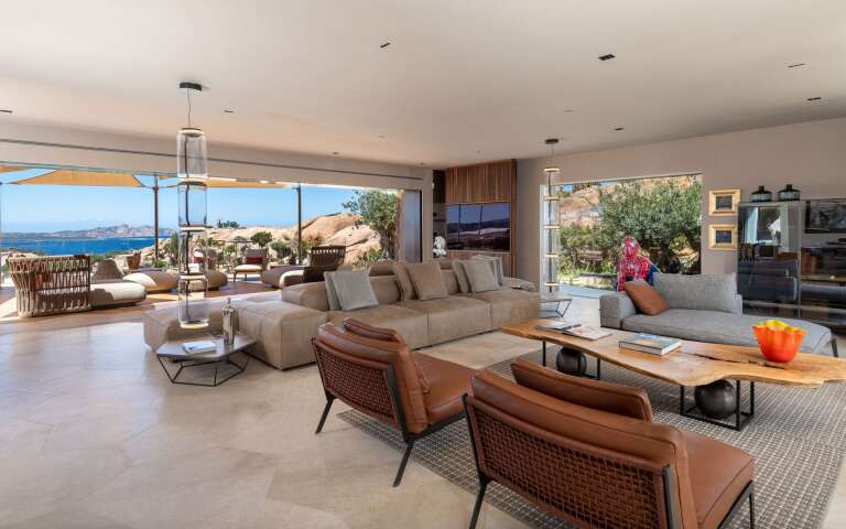 spacious open space living room with comfortable sofas and armchairs