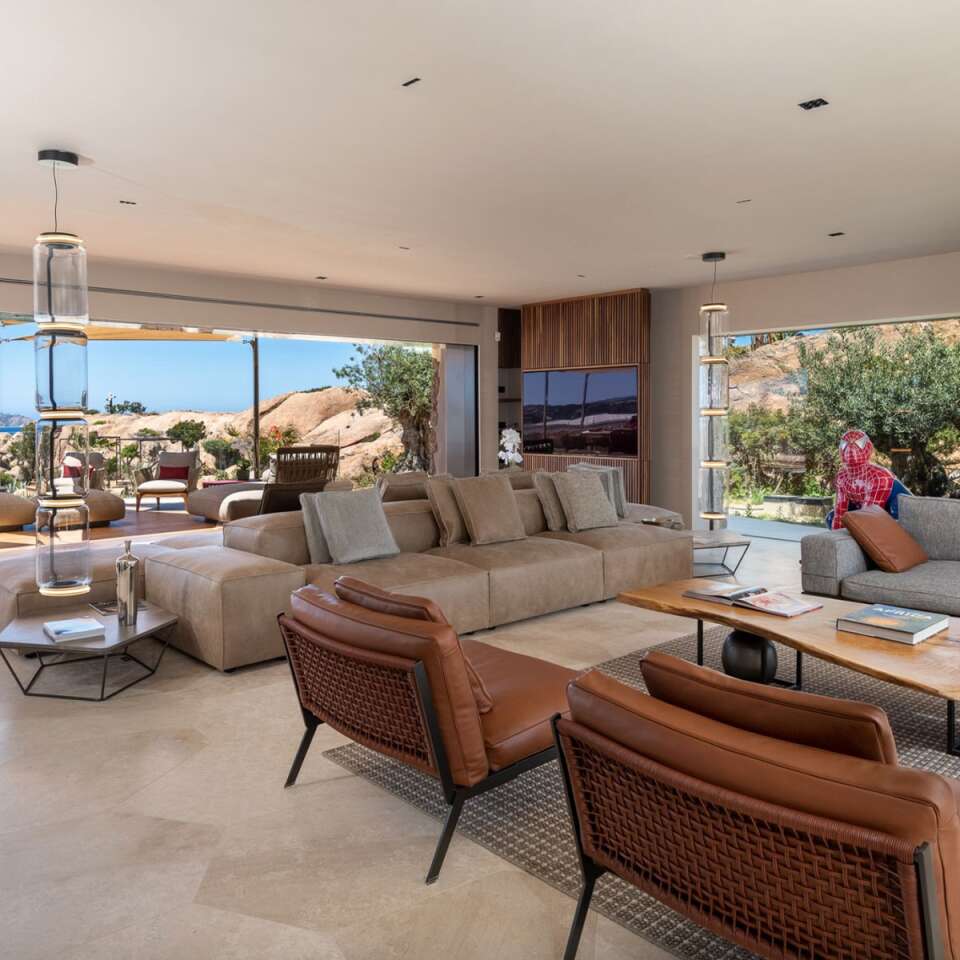 spacious open space living room with comfortable sofas and armchairs