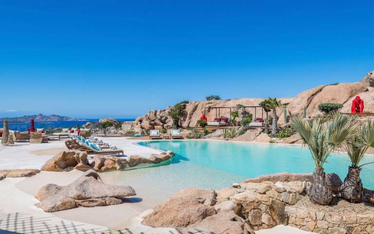 infinity pool with lounge areas and beautiful view