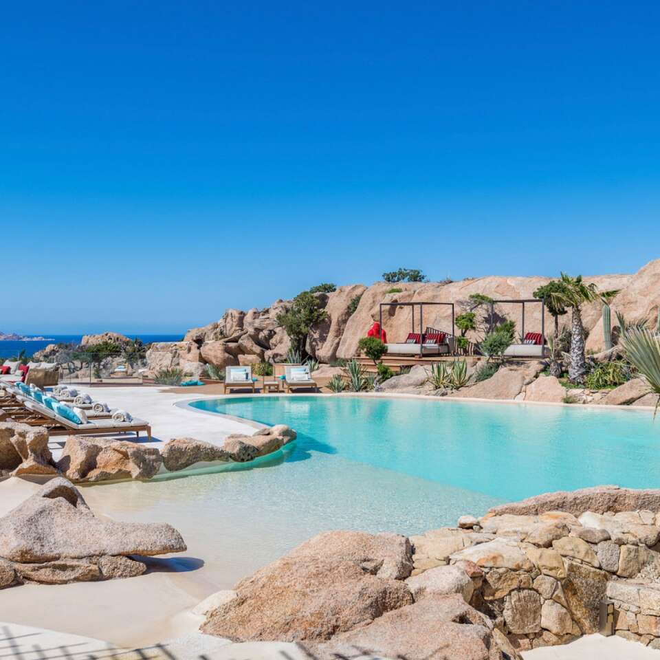 infinity pool with lounge areas and beautiful view