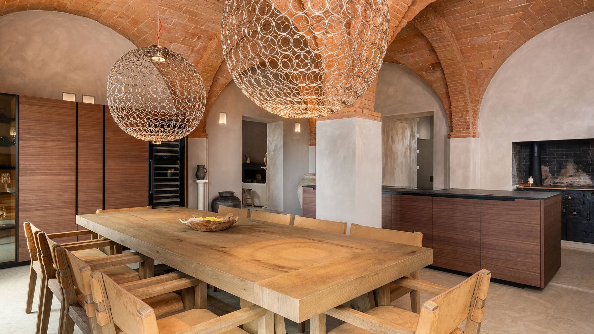 open space kitchen and dining room with exposed brick and vaulted ceilings