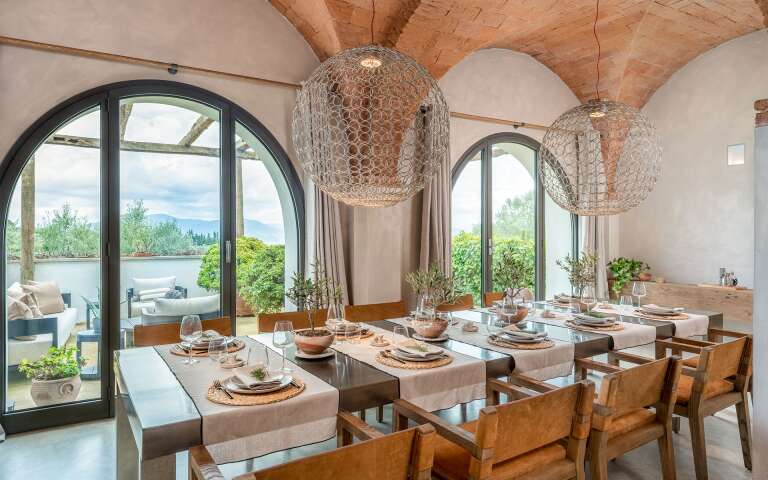 large dining table and arched windows