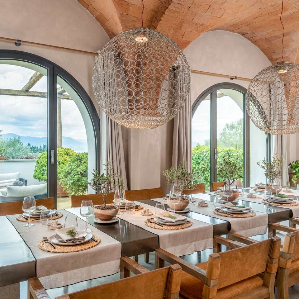 large dining table and arched windows