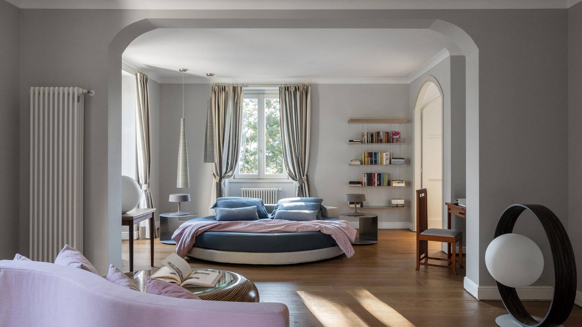 double bedroom with round bed and reading corner