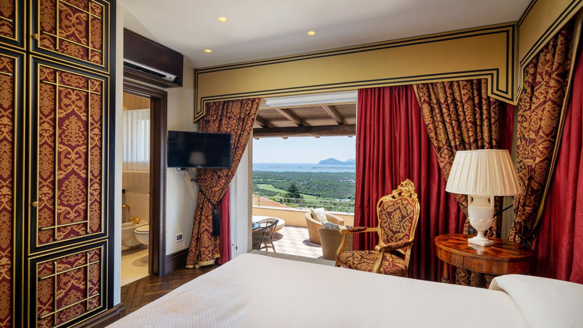 en suite double bedroom with balcony and sea view