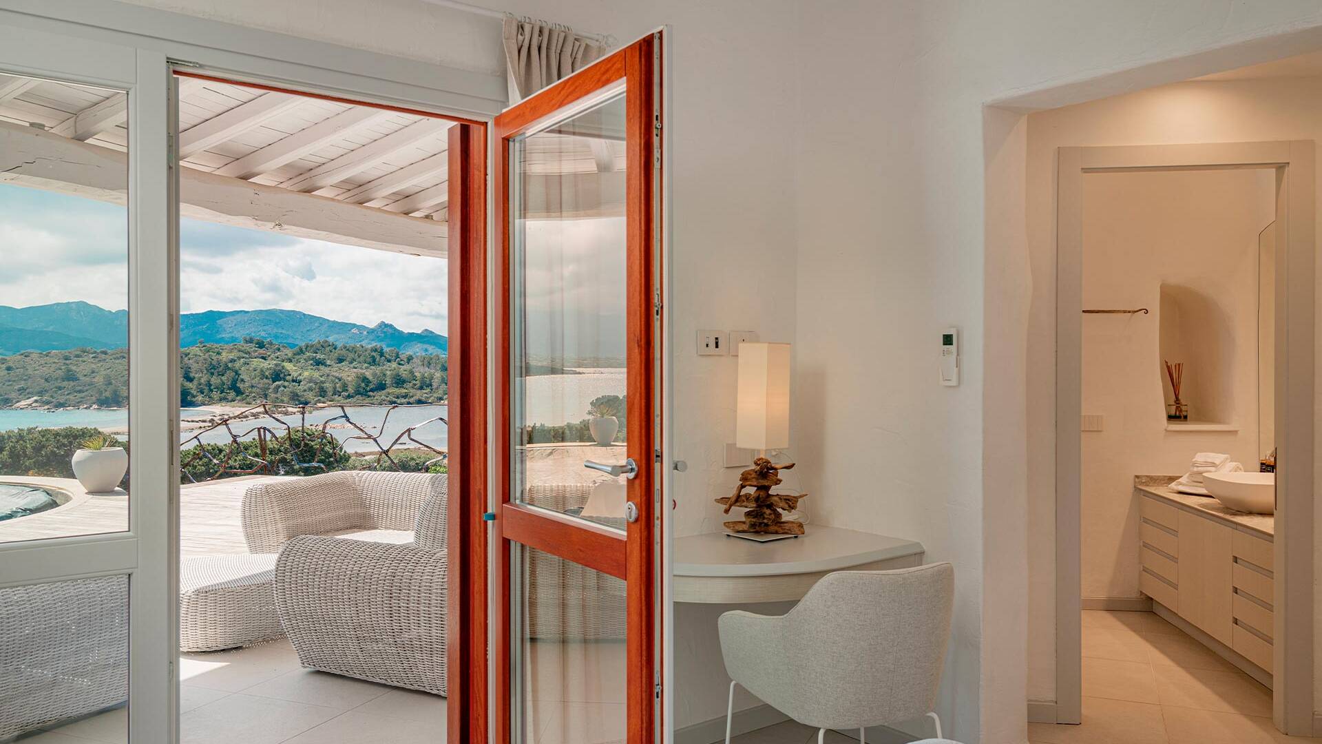 en suite double bedroom with access to the terrace and sea view