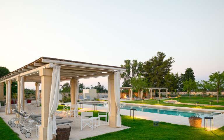 pool area with pergola and lounge area