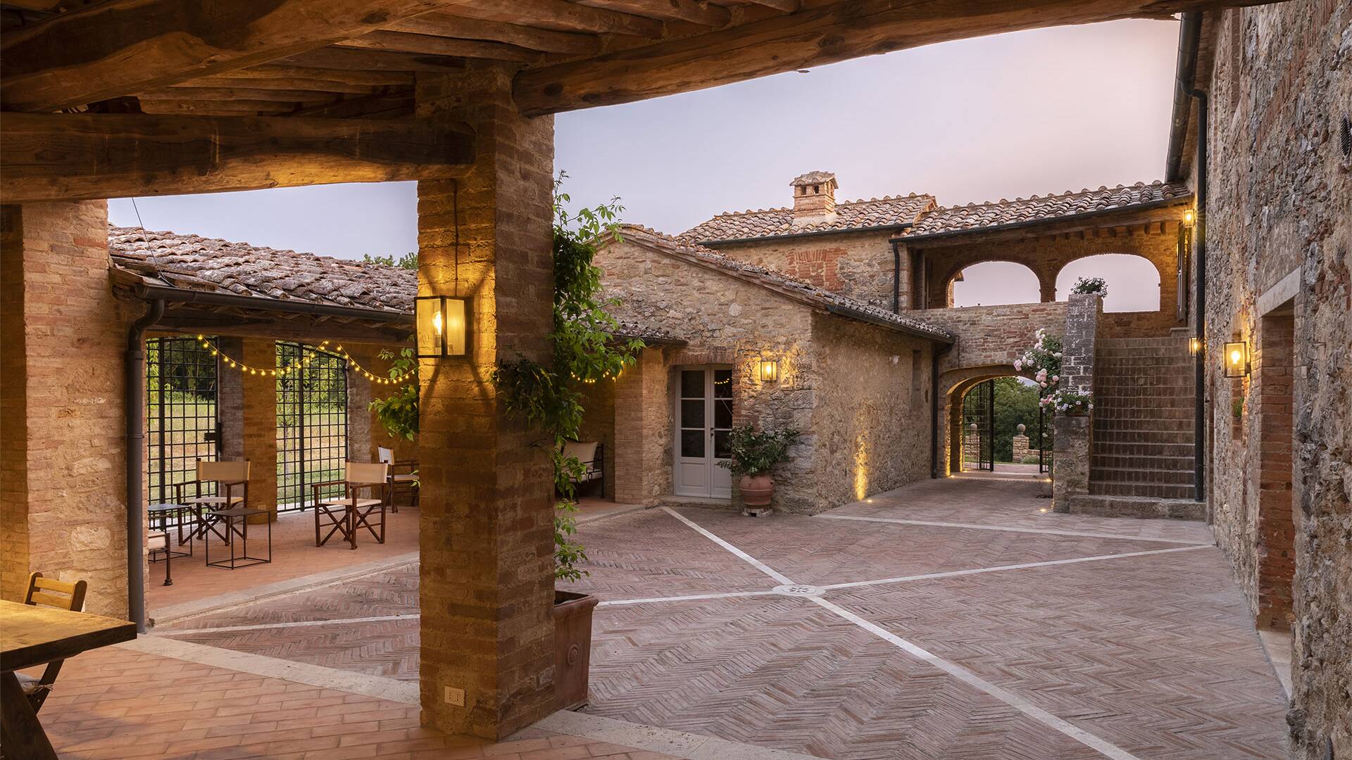 courtyard with covered lounge area and dining table