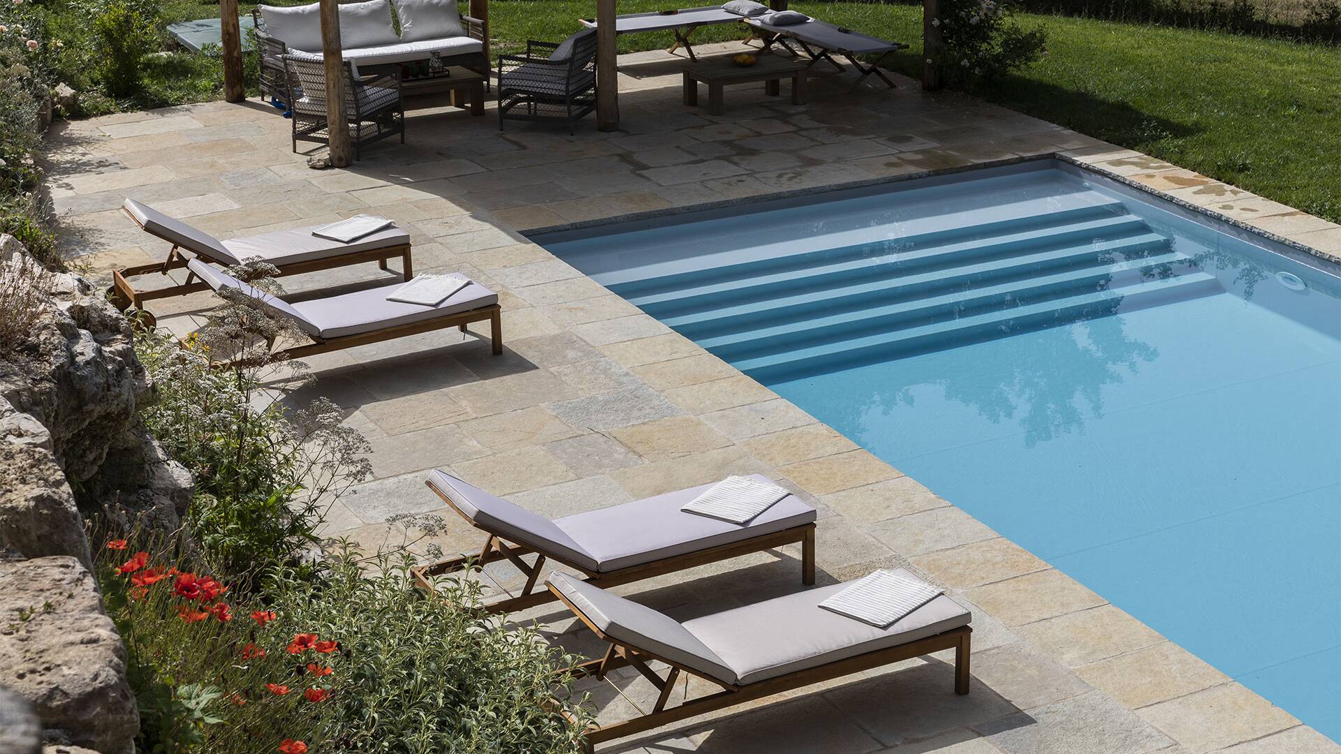 pool area with sun beds 