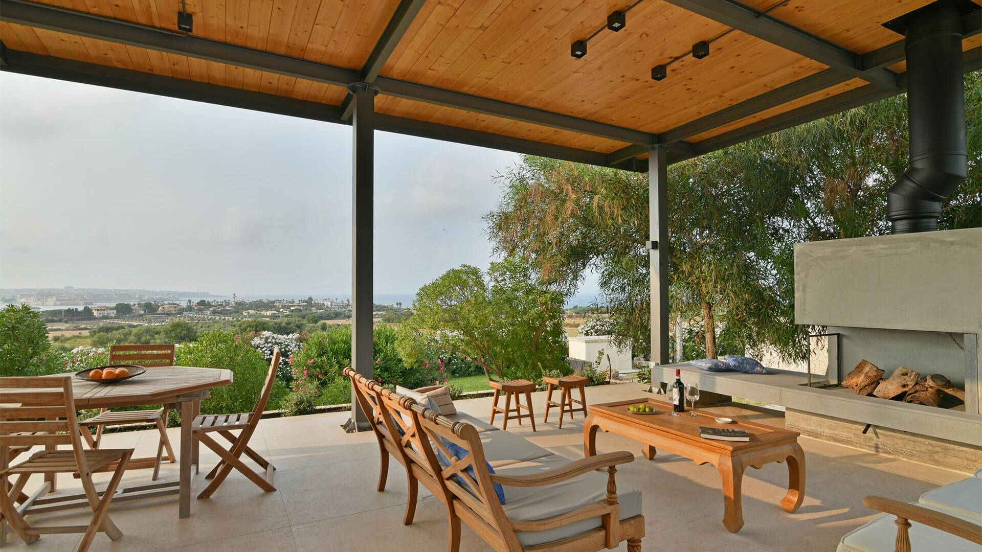 covered terrace with al fresco dining area and fireplace