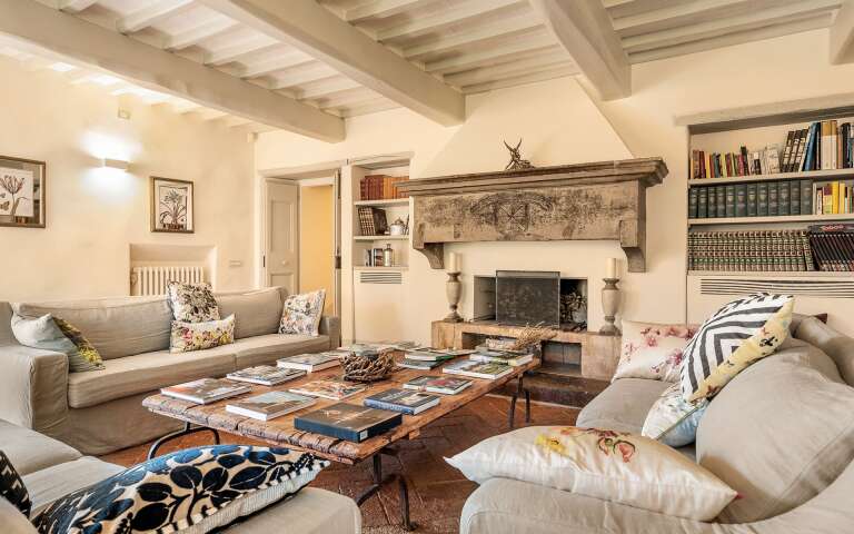 spacious living room with comfortable sofa and fireplace